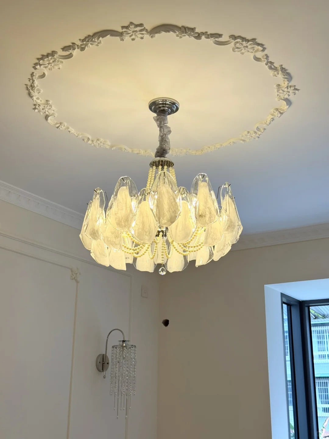 White glass chandelier installed in a classic living room