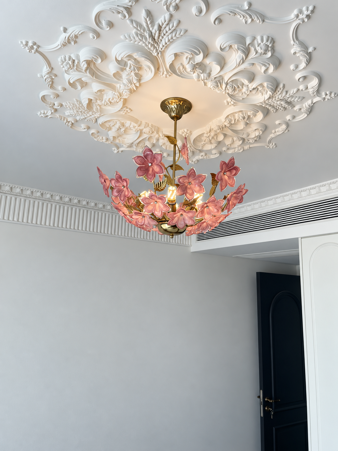 Pink floral Murano-style chandelier installed in a living room